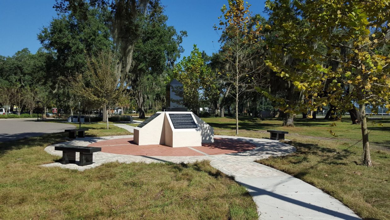 Custom granite bench with engraved military insignias in memorial park